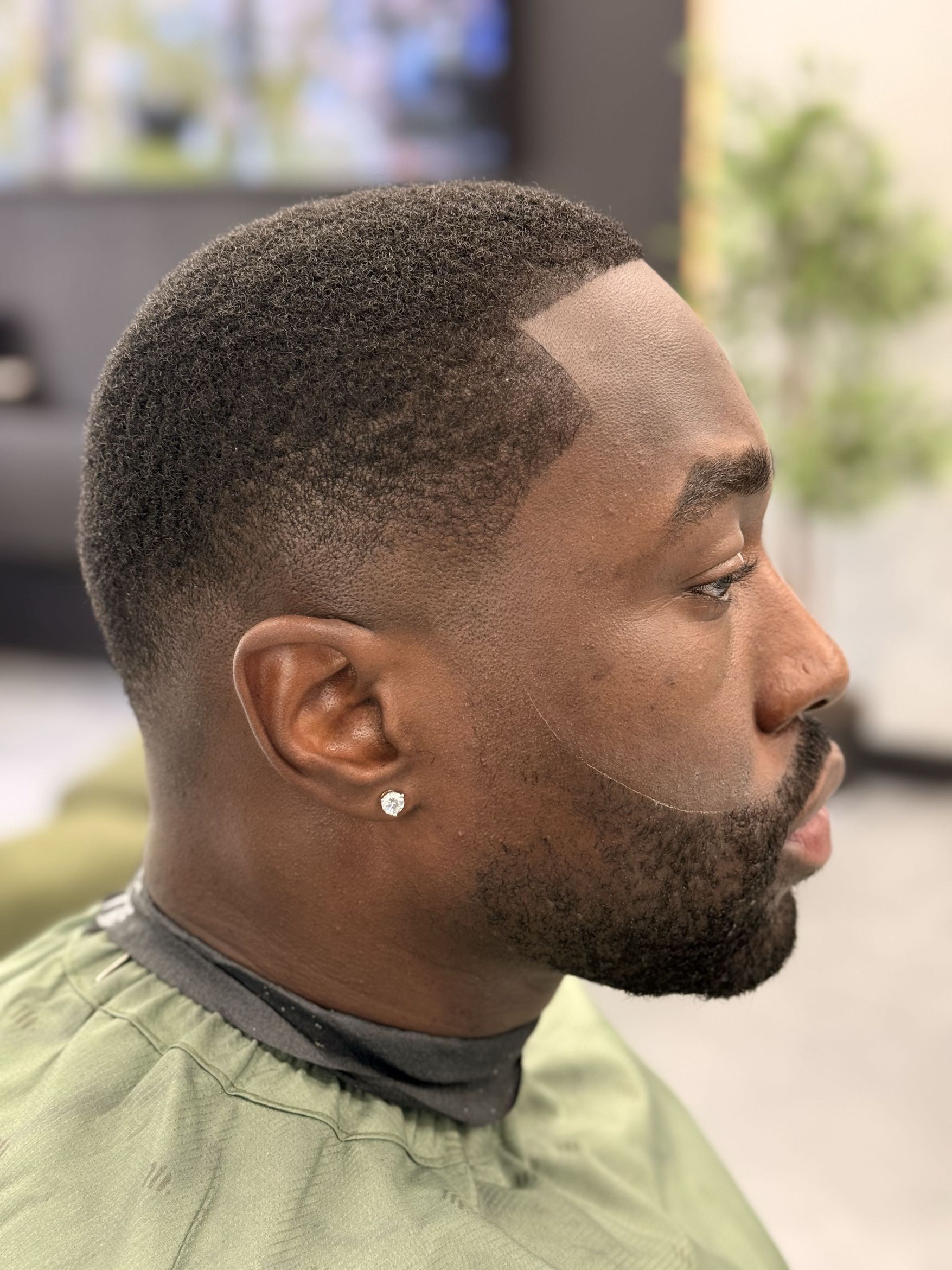 A Velmor haircut with a precise fade and defined beard